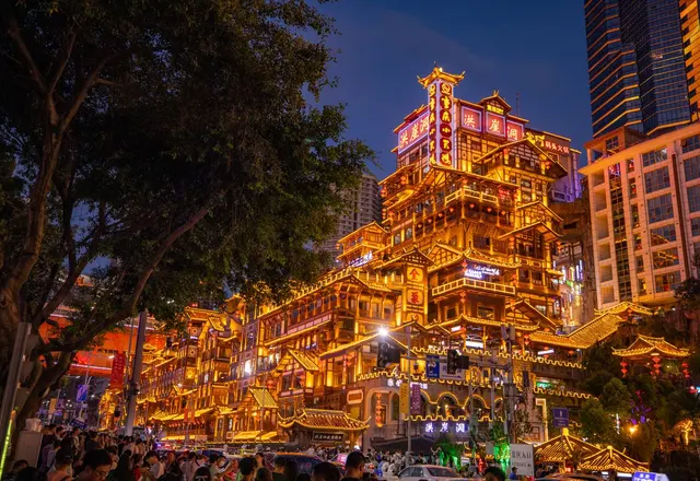 The stacked riverside buildings of Hongyadong illuminated at night in Chongqing