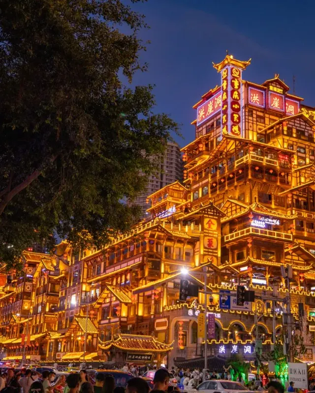 The stacked riverside buildings of Hongyadong illuminated at night in Chongqing