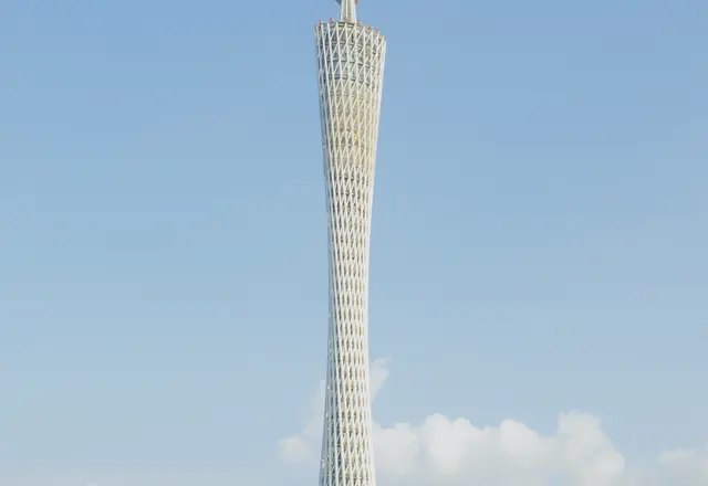 The twisting lattice of Canton Tower against a clear blue sky in Guangzhou