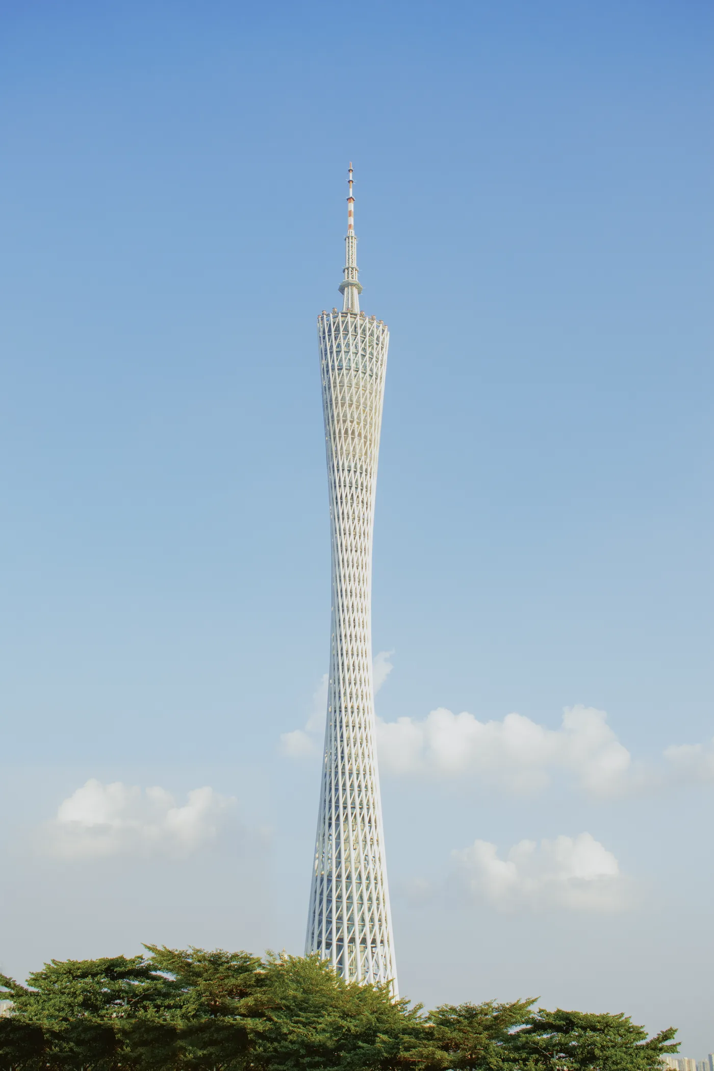 The twisting lattice of Canton Tower against a clear blue sky in Guangzhou