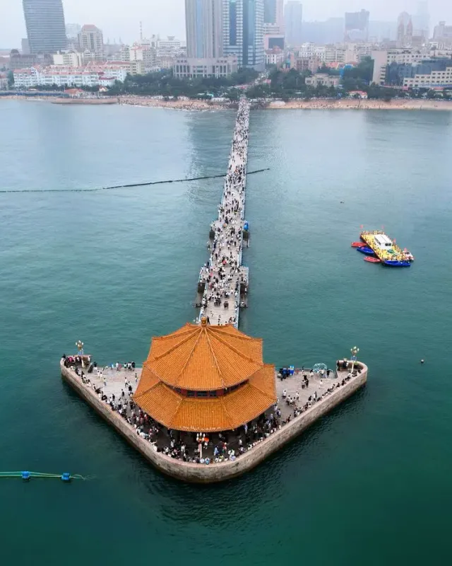 Aerial view of Zhanqiao Pier and Huilan Pavilion extending into the sea in Qingdao