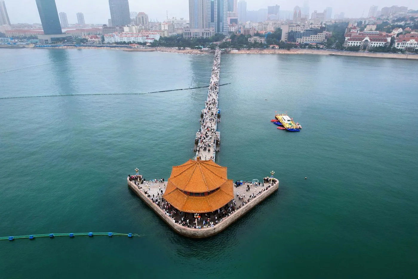 Aerial view of Zhanqiao Pier and Huilan Pavilion extending into the sea in Qingdao