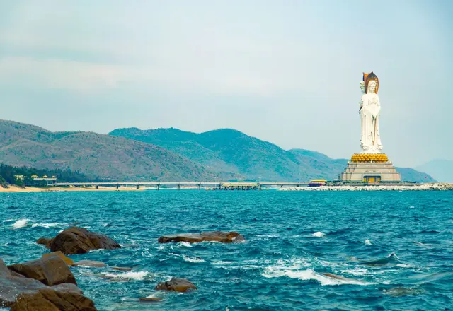 The white Guanyin of Nanshan statue standing above the sea off Sanya, Hainan
