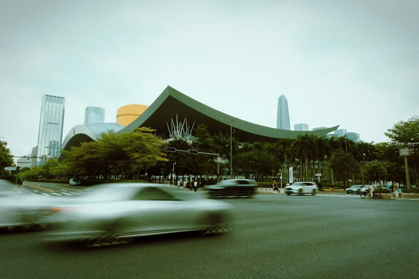 The sweeping green roof of Shenzhen Civic Center with the Futian skyline behind it